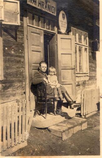 Slovakian Customs administration - the picture shows an officer of the Financial Guard on duty at the frontier with his young daughter on his lap