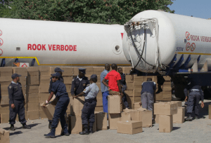 Namibian police inspect over 1,000 boxes of impounded cigarettes at a roadblock in Rundu [Coastweek]